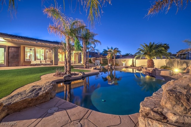 view of pool with fence, a fenced in pool, a patio, and a lawn