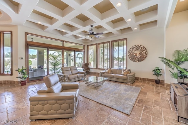 living area with beamed ceiling, coffered ceiling, recessed lighting, and stone tile floors