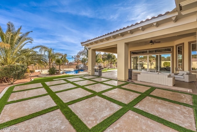 view of patio / terrace featuring a fenced in pool, ceiling fan, and outdoor lounge area