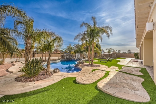 view of yard with a fenced in pool, a patio, and a fenced backyard
