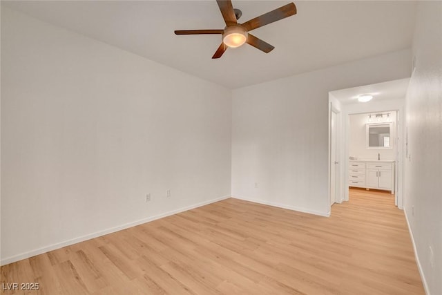 empty room with a ceiling fan, baseboards, and light wood finished floors