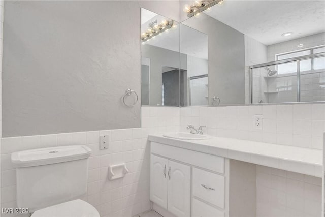 5019 Lancaster Dr, Las Vegas, NV 89120 - full bathroom featuring vanity, toilet, tile walls, and a stall shower