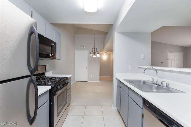 kitchen featuring light countertops, appliances with stainless steel finishes, light carpet, and a sink