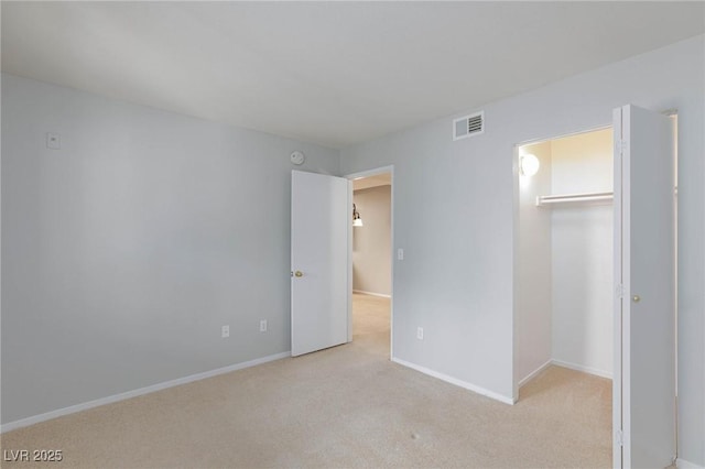 unfurnished bedroom with baseboards, visible vents, carpet, and a closet
