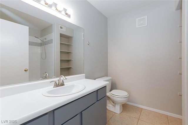 bathroom featuring vanity, tile patterned flooring, a shower, and visible vents