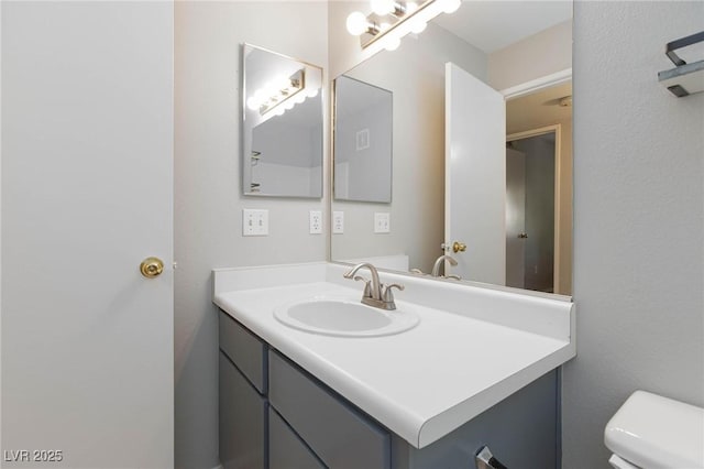 bathroom with toilet and vanity