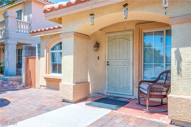 8504 W Gilmore Ave, Las Vegas, NV 89129 - property entrance with stucco siding and a tiled roof