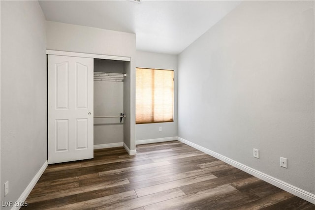 8504 W Gilmore Ave, Las Vegas, NV 89129 - unfurnished bedroom featuring dark wood-style floors, a closet, and baseboards