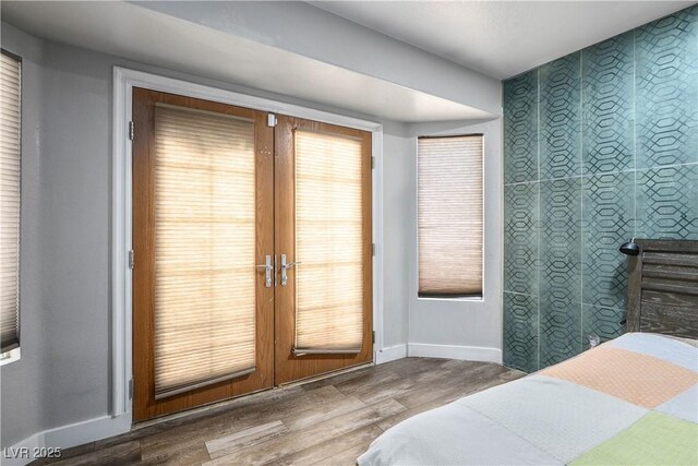 8504 W Gilmore Ave, Las Vegas, NV 89129 - bedroom with wood finished floors, baseboards, and french doors