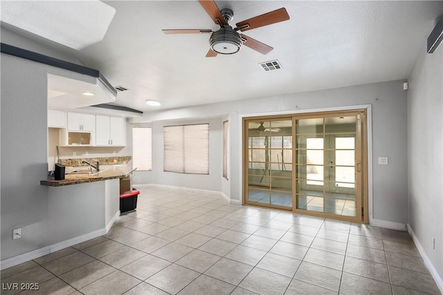 8504 W Gilmore Ave, Las Vegas, NV 89129 - unfurnished living room with a ceiling fan, plenty of natural light, and a sink