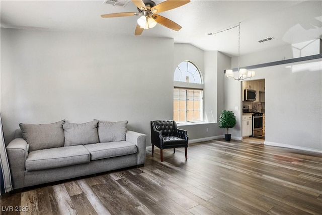 8504 W Gilmore Ave, Las Vegas, NV 89129 - living area with a chandelier, dark wood finished floors, a ceiling fan, baseboards, and vaulted ceiling