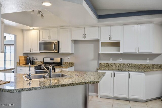 8504 W Gilmore Ave, Las Vegas, NV 89129 - kitchen with appliances with stainless steel finishes, a tray ceiling, white cabinets, a sink, and stone countertops
