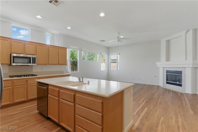 kitchen with visible vents, ceiling fan, light countertops, a sink, and appliances with stainless steel finishes