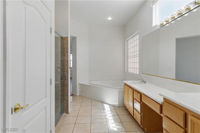 full bathroom with tile patterned flooring, double vanity, a bath, a shower stall, and a sink