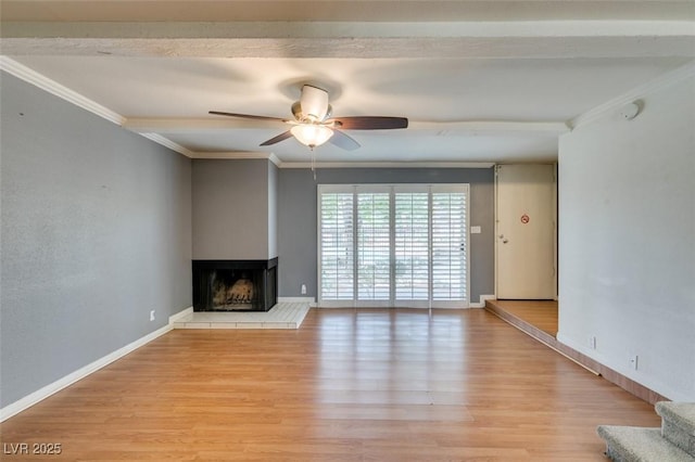 516 Delfern Ln, Las Vegas, NV 89169 - unfurnished living room featuring ornamental molding, ceiling fan, a multi sided fireplace, wood finished floors, and baseboards