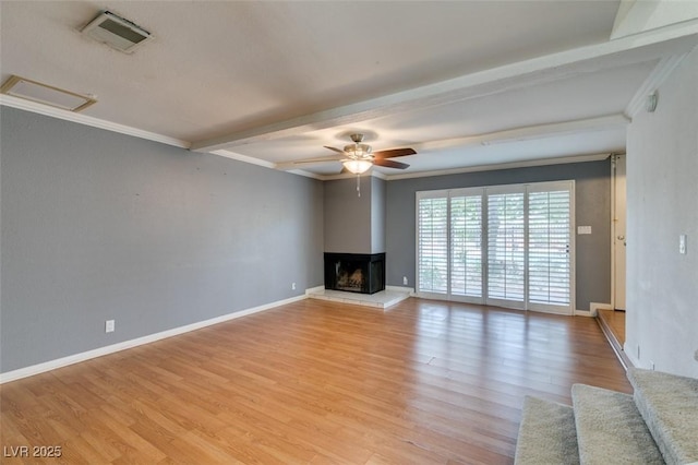 516 Delfern Ln, Las Vegas, NV 89169 - unfurnished living room featuring beam ceiling, ornamental molding, a multi sided fireplace, light wood-style flooring, and ceiling fan