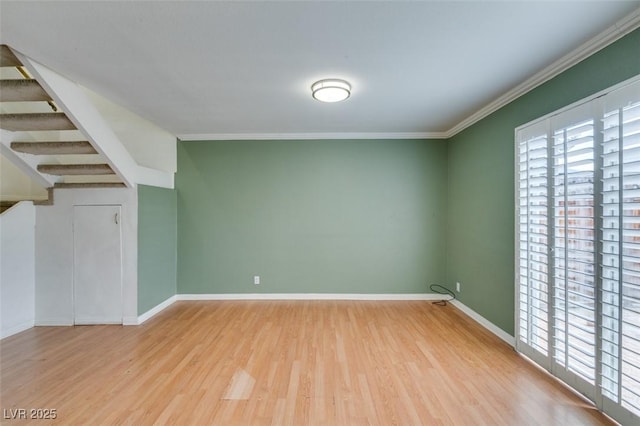516 Delfern Ln, Las Vegas, NV 89169 - unfurnished room with healthy amount of natural light, wood finished floors, crown molding, baseboards, and stairway