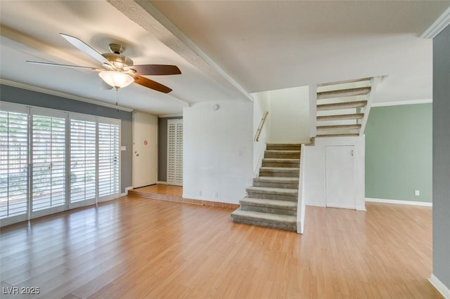 516 Delfern Ln, Las Vegas, NV 89169 - unfurnished living room featuring a ceiling fan, stairs, light wood-style floors, and baseboards