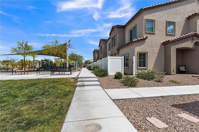view of property's community with fence and a yard