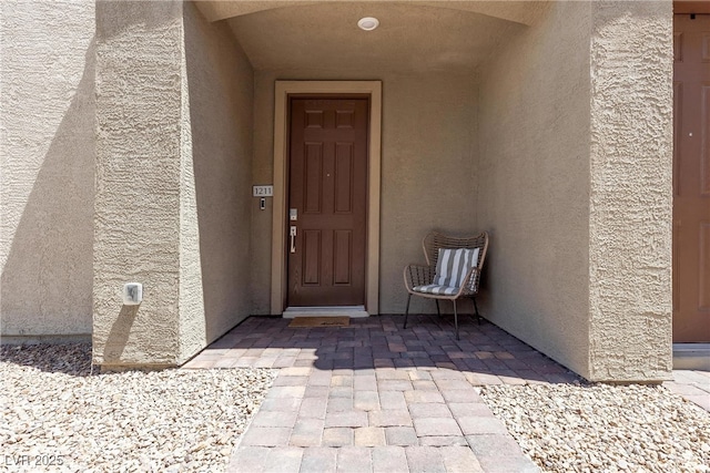 doorway to property with stucco siding