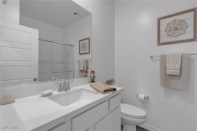 full bath featuring vanity, an enclosed shower, visible vents, and toilet