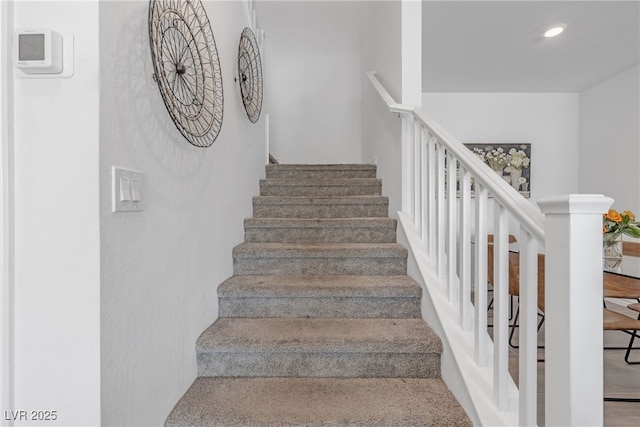 staircase featuring recessed lighting