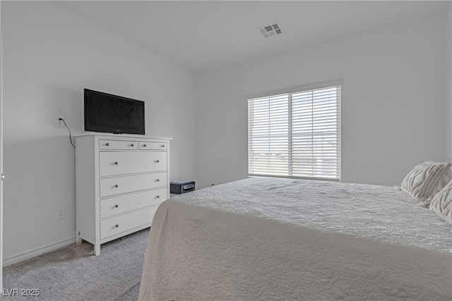 bedroom featuring visible vents, baseboards, and light colored carpet