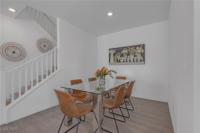 dining space featuring stairway, baseboards, recessed lighting, and wood finished floors