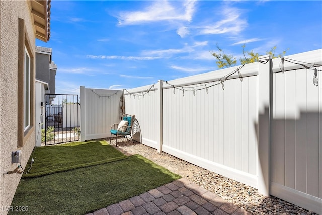 view of yard with fence and a gate