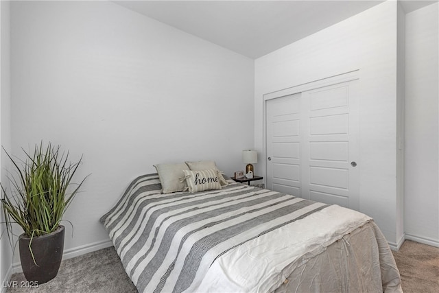 carpeted bedroom with baseboards and a closet
