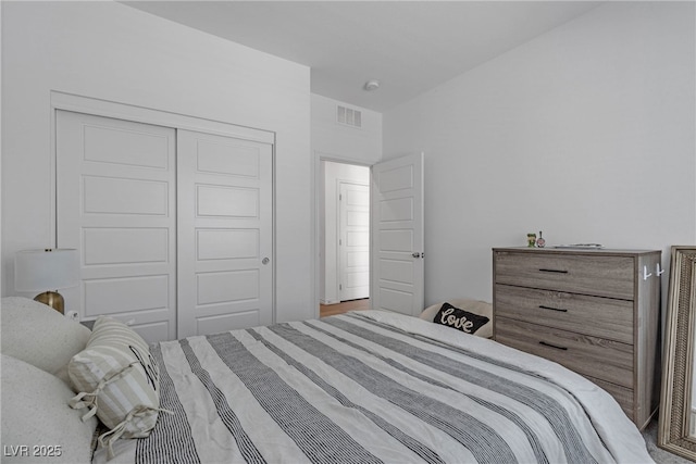 bedroom with visible vents and a closet