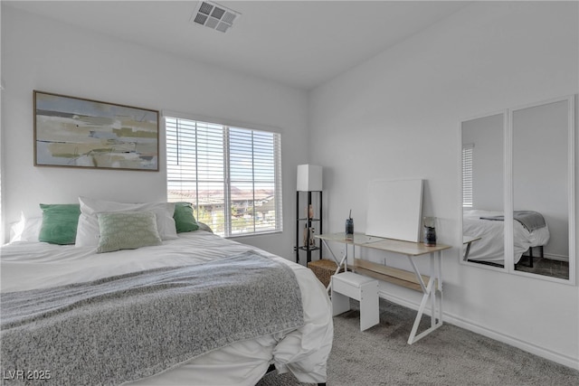 carpeted bedroom featuring baseboards and visible vents