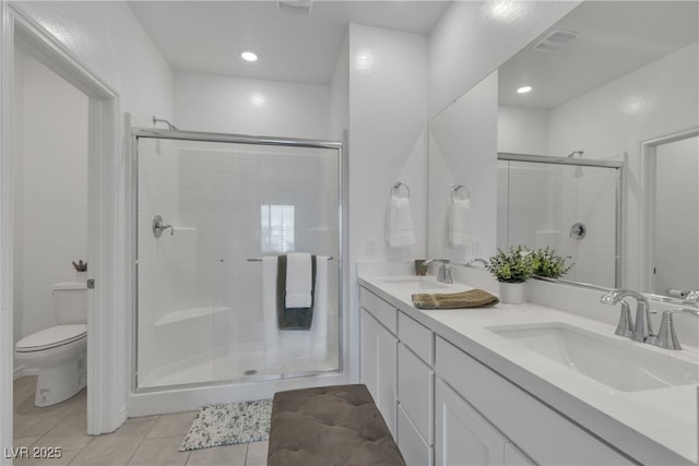 full bathroom with a sink, tile patterned floors, a stall shower, and toilet