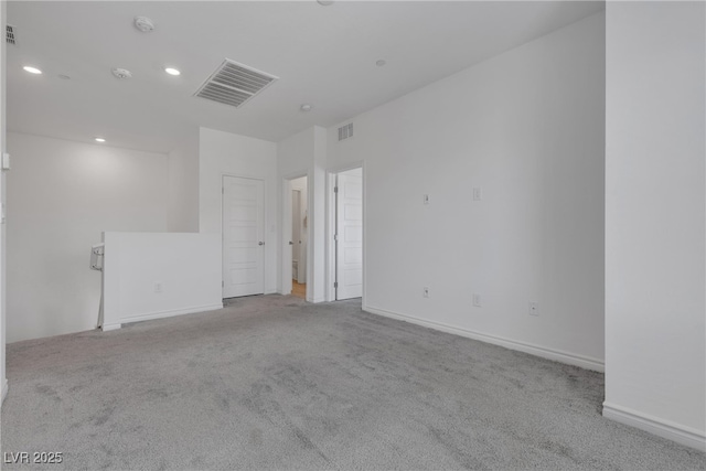 unfurnished room featuring recessed lighting, visible vents, and carpet