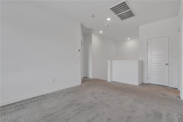 spare room with recessed lighting, baseboards, visible vents, and carpet