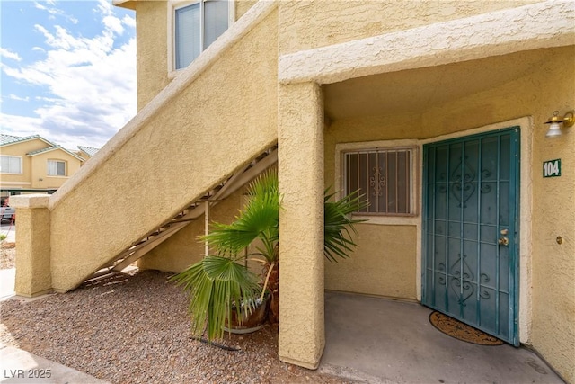 view of exterior entry with stucco siding