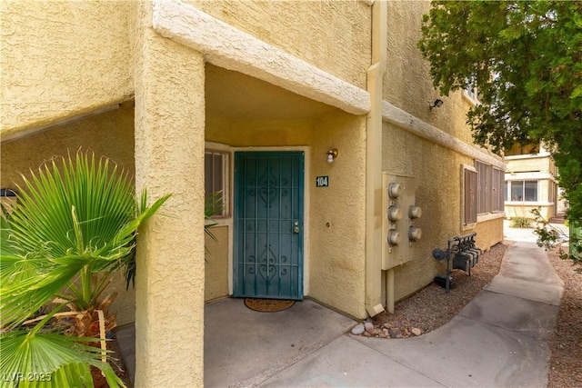 view of exterior entry with stucco siding