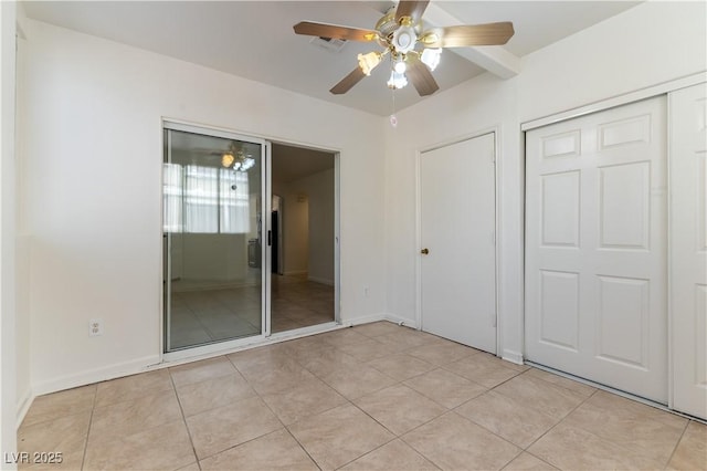 unfurnished bedroom featuring baseboards, visible vents, light tile patterned floors, and a closet