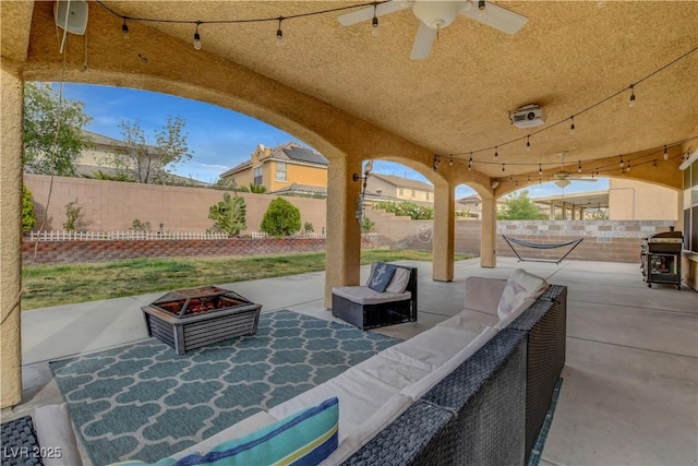 view of patio with a fenced backyard, ceiling fan, and outdoor lounge area