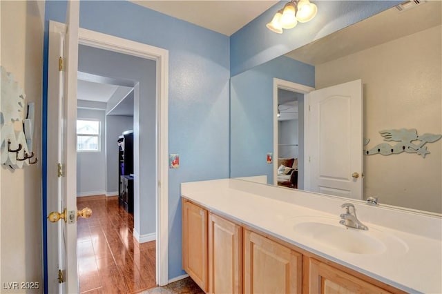 bathroom featuring baseboards, visible vents, and vanity