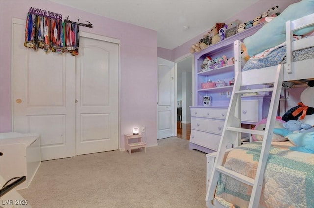 bedroom with a closet and light carpet