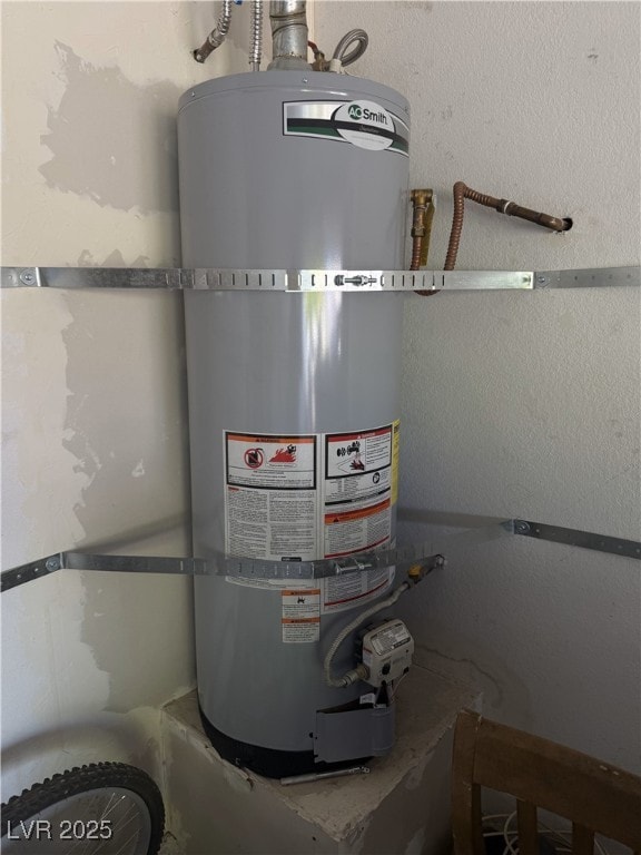 utility room featuring water heater