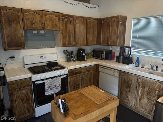kitchen featuring a sink and white appliances