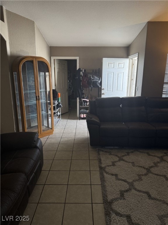 living area featuring tile patterned floors and french doors