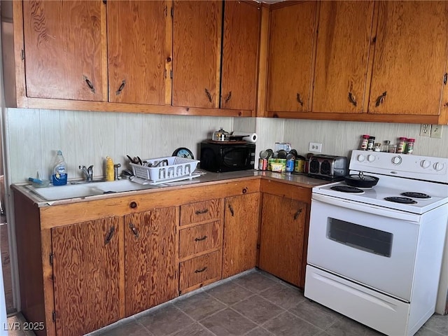 kitchen featuring brown cabinetry, electric range, black microwave, a toaster, and a sink