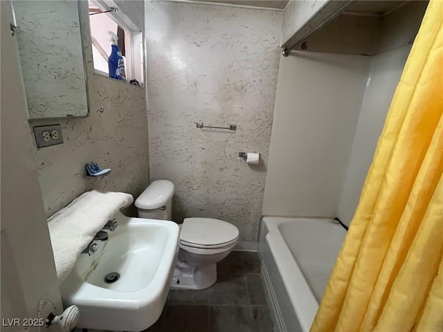 bathroom with a sink, tile patterned floors, and toilet