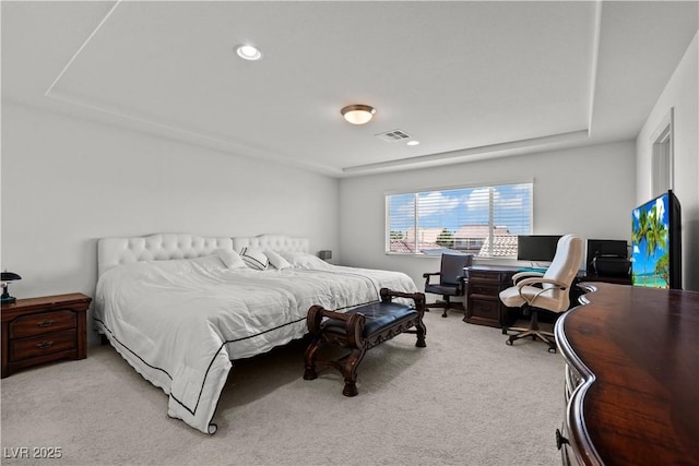 bedroom featuring visible vents, recessed lighting, a tray ceiling, and light carpet