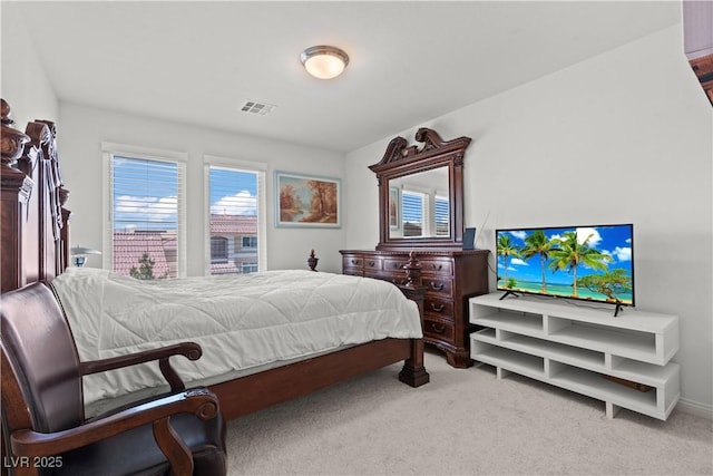 carpeted bedroom featuring visible vents