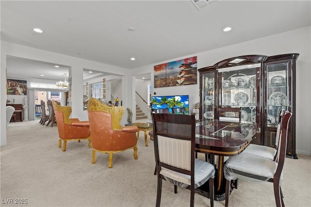 carpeted dining space featuring recessed lighting, visible vents, stairway, and an inviting chandelier