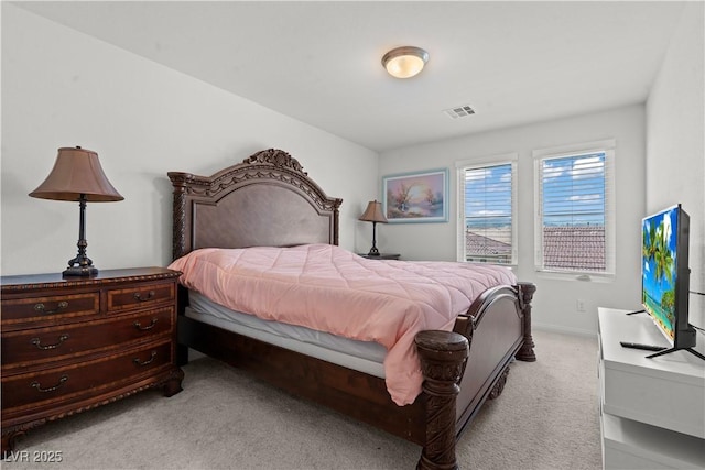 bedroom featuring light colored carpet and visible vents